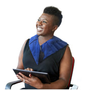 User wearing warming shoulder wrap while relaxing for targeted comfort