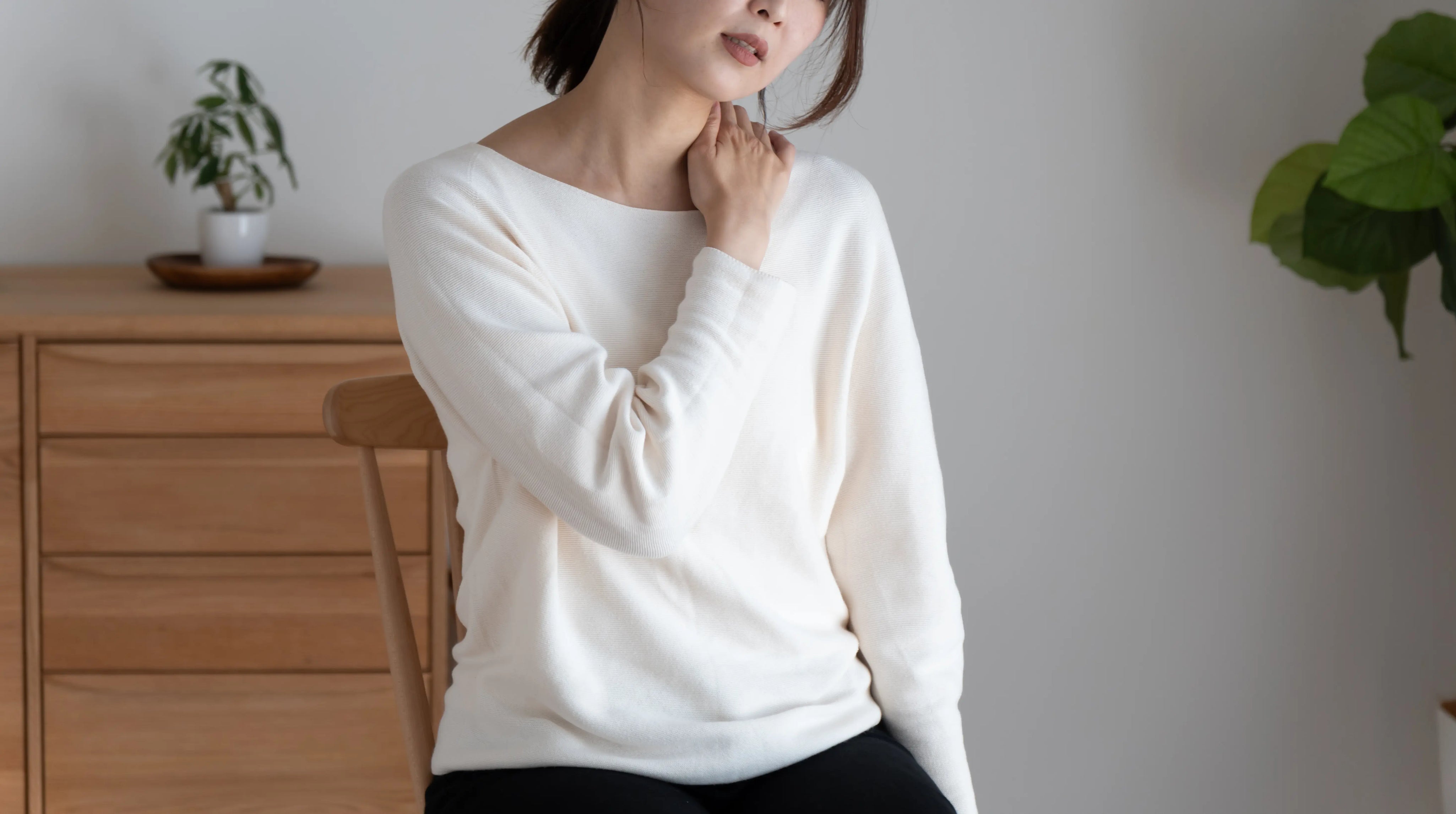 Woman holding her shoulder due to frozen shoulder pain during menopause