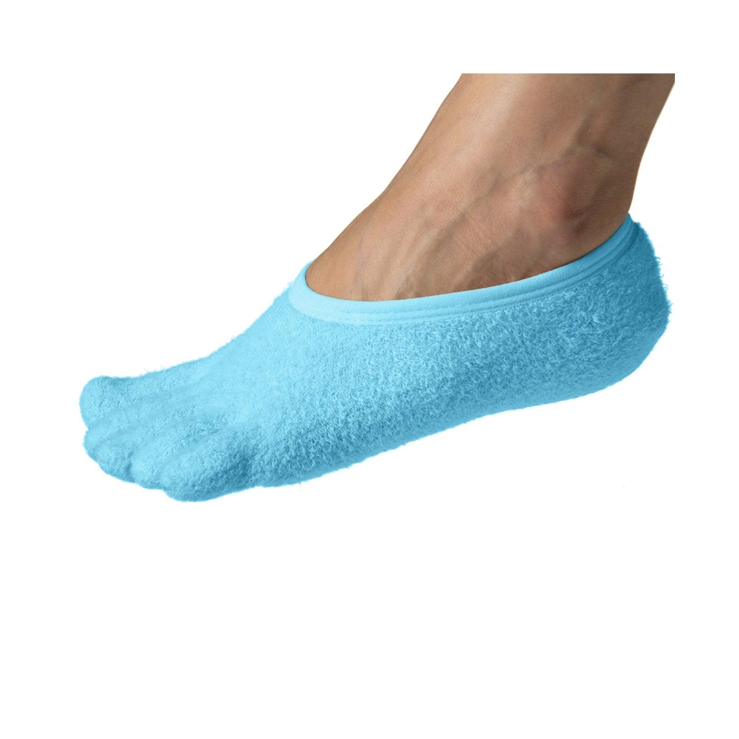 The girl puts on a moisturizing foot mask, for dry heels of the feet. Woman  wearing disposable moisturizing socks for the legs. Close-up of woman's feet  wrapped in moisturizing socks Stock Photo |